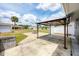 Large backyard with a covered patio, a fire pit and a storage shed on a sunny day at 18348 Yale Ave, Port Charlotte, FL 33948