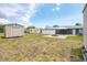 Wide backyard view including several outbuildings, fire pit and paved patio area at 18348 Yale Ave, Port Charlotte, FL 33948