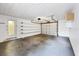 Spacious garage featuring an open garage door, shelving along the left wall and high ceilings at 18348 Yale Ave, Port Charlotte, FL 33948