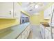 Efficient kitchen with white cabinets and a view into the adjacent living area at 18348 Yale Ave, Port Charlotte, FL 33948