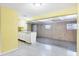 Open kitchen with white cabinets and an adjacent room for flexible use at 18348 Yale Ave, Port Charlotte, FL 33948