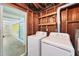 Convenient laundry area with a washer and dryer next to sliding glass doors to an adjacent room at 18348 Yale Ave, Port Charlotte, FL 33948