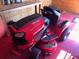 Craftsman riding lawn mower with grass collecting on the mower deck and red flooring at 18348 Yale Ave, Port Charlotte, FL 33948