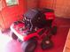 Interior of a shed with a red Craftsman riding lawn mower at 18348 Yale Ave, Port Charlotte, FL 33948