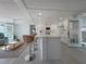 Bright kitchen features a breakfast bar with marble countertop and modern appliances at 2107 Palma Sola Blvd # 23, Bradenton, FL 34209