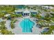 An aerial view of a stunning pool and clubhouse surrounded by landscaping, lounge chairs, and community amenities at 2309 Blue Mahoe Ln, Sarasota, FL 34240