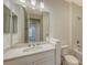 Bright bathroom featuring a vanity, a large mirror, and a bathtub with white tiled walls at 2309 Blue Mahoe Ln, Sarasota, FL 34240