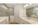 Elegant bathroom with double vanity, quartz countertops, decorative mirrors, and tiled walk-in shower at 2309 Blue Mahoe Ln, Sarasota, FL 34240