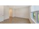 Bright bedroom featuring wood-look tile flooring, neutral walls, and a window, creating a serene atmosphere at 2309 Blue Mahoe Ln, Sarasota, FL 34240