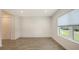 Bedroom with wood-look tile flooring, closet, and natural light from a window at 2309 Blue Mahoe Ln, Sarasota, FL 34240
