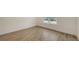 Bedroom featuring wood-look tile flooring, natural light, and neutral-colored walls at 2309 Blue Mahoe Ln, Sarasota, FL 34240