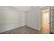 Minimal bedroom with neutral walls, wood-look tile flooring, and ample natural light, offering a calming space at 2309 Blue Mahoe Ln, Sarasota, FL 34240