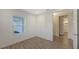 Neutral bedroom with wood-look tile, a window and doorway to the next room with a small bathroom visible at 2309 Blue Mahoe Ln, Sarasota, FL 34240