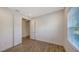 Cozy empty bedroom features wood-look tile flooring, a window and a doorway into the next room at 2309 Blue Mahoe Ln, Sarasota, FL 34240