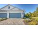 Two-story home exterior featuring a two car garage, brick driveway and manicured landscaping at 2309 Blue Mahoe Ln, Sarasota, FL 34240