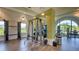 Spacious gym with weight racks, a smith machine, and an arched window providing natural light at 2309 Blue Mahoe Ln, Sarasota, FL 34240