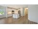 Open concept kitchen with island, stainless steel appliances, and view to the living room at 2309 Blue Mahoe Ln, Sarasota, FL 34240