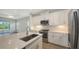 Beautiful, modern kitchen with stainless steel appliances, stone countertops and attached great room at 2309 Blue Mahoe Ln, Sarasota, FL 34240