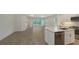 Modern kitchen with an open layout, white cabinets, stainless steel appliances and wood-look tile flooring at 2309 Blue Mahoe Ln, Sarasota, FL 34240