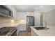 Kitchen features stainless appliances, white cabinets, granite countertops, and a view into the hallway at 2309 Blue Mahoe Ln, Sarasota, FL 34240