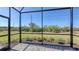 View of the screened lanai and view of the outdoors at 2309 Blue Mahoe Ln, Sarasota, FL 34240