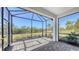 Screened lanai features a brick floor with views of trees and the outdoors at 2309 Blue Mahoe Ln, Sarasota, FL 34240