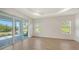 Light-filled living space featuring tile floors and sliding glass doors to the outdoors at 2309 Blue Mahoe Ln, Sarasota, FL 34240
