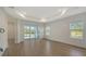 Spacious living room featuring wood-look tile flooring and sliding glass doors to a patio at 2309 Blue Mahoe Ln, Sarasota, FL 34240