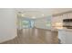Spacious living room with decorative recessed lighting, tile flooring, with kitchen in the background at 2309 Blue Mahoe Ln, Sarasota, FL 34240