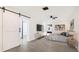 Comfortable main bedroom featuring a sliding barn door, stylish decor, and ample natural light at 2539 Huntington Ave, Sarasota, FL 34232