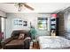 Comfortable bedroom features unique wall art, a ceiling fan, and warm natural light at 2678 Rock Creek Dr, Port Charlotte, FL 33948