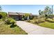 The property features a well-maintained lawn, a paved driveway, and an attached garage at 2678 Rock Creek Dr, Port Charlotte, FL 33948