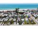 A vibrant coastal neighborhood with colorful homes steps away from a white sandy beach at 2714 Avenue C, Holmes Beach, FL 34217