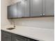 Laundry room with gray cabinets, white quartz countertops, and stainless steel sink at 3110 Tolmino Ct, Bradenton, FL 34211