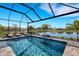 Sparkling private pool with sun loungers and scenic lake views in a screened enclosure at 3110 Tolmino Ct, Bradenton, FL 34211