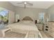 Bedroom featuring a king bed, sliding glass doors to lanai, plantation shutters, and coastal decor at 320 Bermuda Ct, Venice, FL 34293
