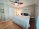 Comfortable bedroom with a ceiling fan, queen-size bed, and hardwood floors at 321 Reclinata Cir, Venice, FL 34292