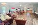 Spacious community room features lounge seating, dining area, kitchen, and fitness equipment at 321 Reclinata Cir, Venice, FL 34292