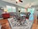 Open-concept dining room featuring hardwood floors and lots of natural light with views to the living room at 321 Reclinata Cir, Venice, FL 34292