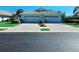 A well-maintained home with a tile roof, two-car garage, and tidy front yard at 321 Reclinata Cir, Venice, FL 34292