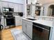 Bright kitchen includes stainless steel appliances, gray cabinets, and a pass-through bar overlooking the living area at 321 Reclinata Cir, Venice, FL 34292