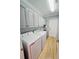 Bright laundry room featuring shaker cabinets, a sink, and a full size washer and dryer at 321 Reclinata Cir, Venice, FL 34292