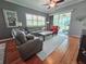 Bright living room featuring hardwood floors, comfortable seating, and sliding glass doors to the outdoor patio at 321 Reclinata Cir, Venice, FL 34292