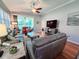 Spacious living room with comfortable seating, hardwood floors, and a sliding glass door at 321 Reclinata Cir, Venice, FL 34292