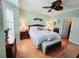 Spacious main bedroom featuring wood floors, plantation shutters, and en-suite bathroom access at 321 Reclinata Cir, Venice, FL 34292