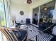 Stylish sun room with a black and white rug, comfortable seating, and modern decor at 321 Reclinata Cir, Venice, FL 34292