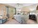 Cozy bedroom with a plush queen-sized bed, ceiling fan, and natural light from the window at 3365 Cross Creek Dr # 3365, Sarasota, FL 34231