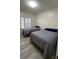 Bedroom with wood flooring featuring two beds and a window that provides natural light at 3702 54Th W Dr # 103, Bradenton, FL 34210