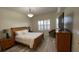 Inviting bedroom with wood flooring, a dresser, and a window that provides natural light at 3702 54Th W Dr # 103, Bradenton, FL 34210