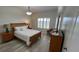 Bedroom featuring wood flooring, a dresser, TV, and a window that provides natural light at 3702 54Th W Dr # 103, Bradenton, FL 34210